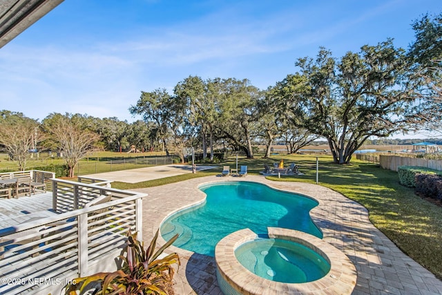 view of pool featuring an in ground hot tub, a yard, and a patio