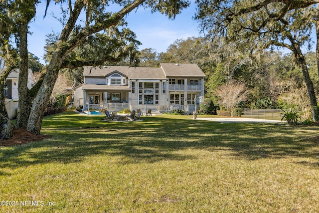 view of front of home with a balcony and a front lawn