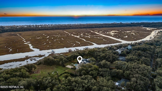 aerial view at dusk with a water view