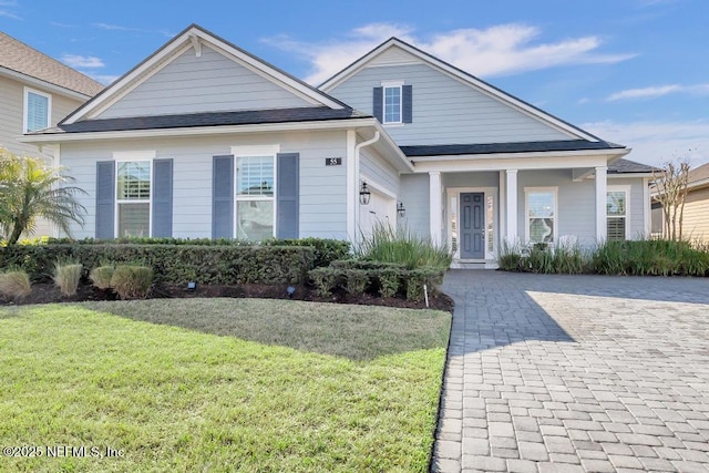 view of front of home featuring a garage and a front lawn