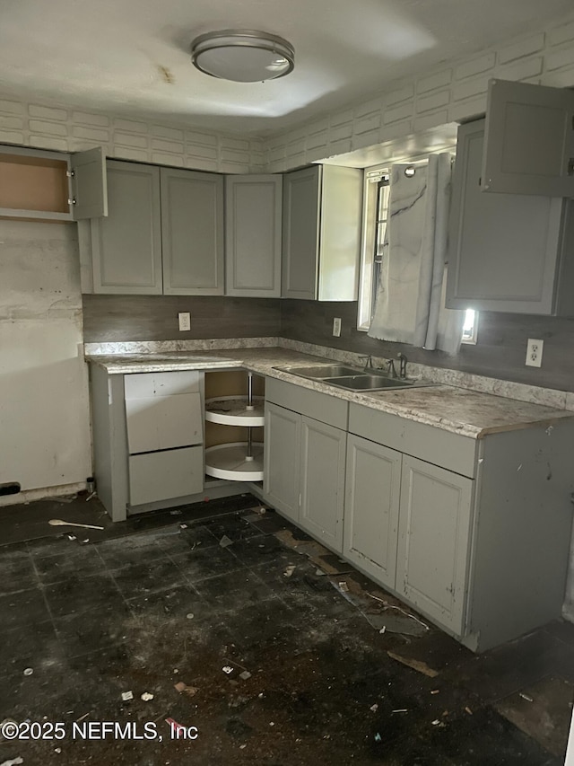 kitchen featuring sink and gray cabinets