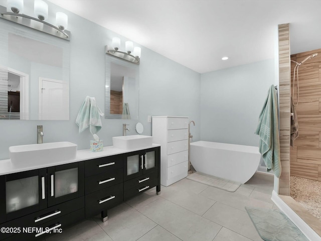 bathroom featuring vanity, plus walk in shower, and tile patterned flooring