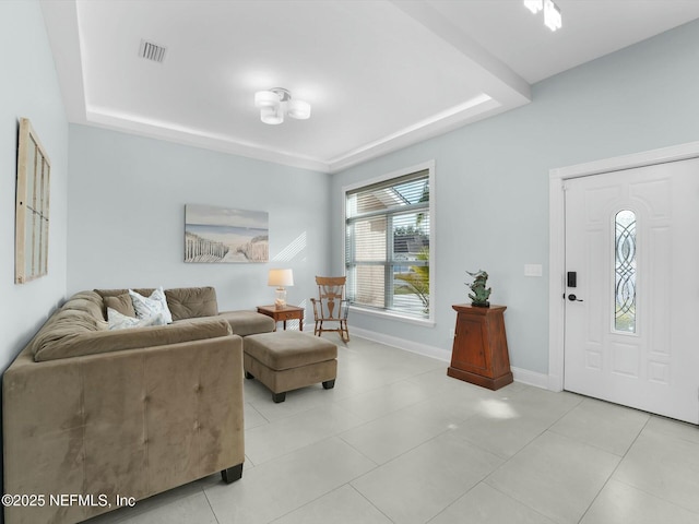 tiled living room with a raised ceiling