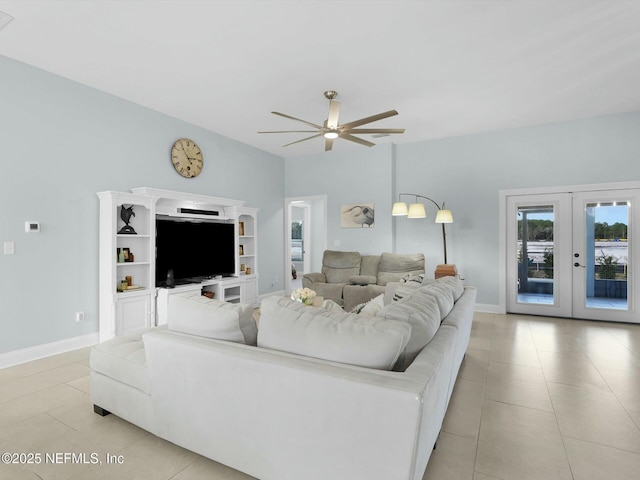 tiled living room featuring ceiling fan and french doors