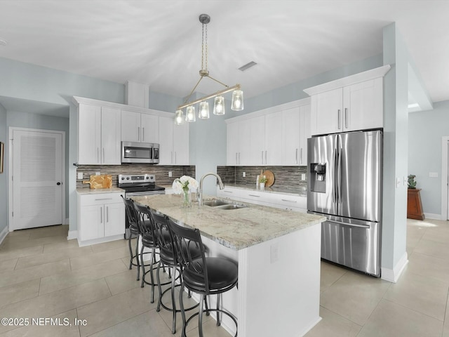 kitchen with white cabinetry, appliances with stainless steel finishes, and sink