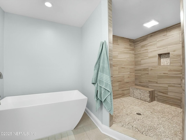 bathroom featuring tile patterned floors and shower with separate bathtub