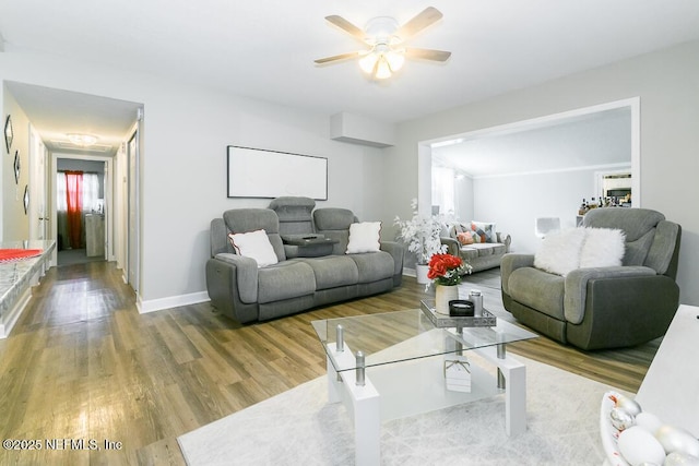 living room featuring ceiling fan and light wood-type flooring