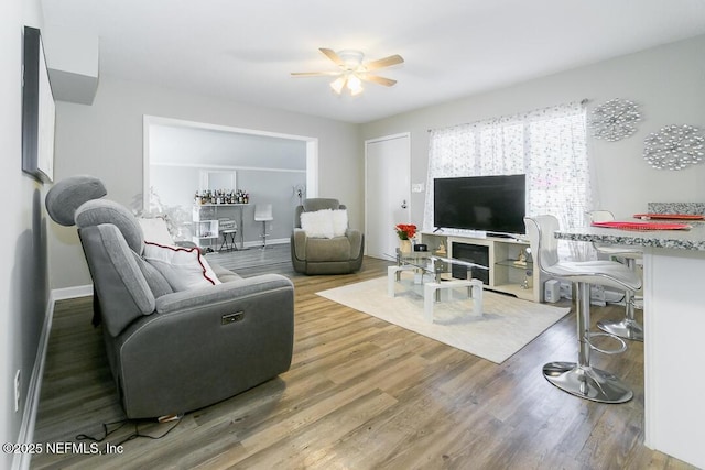 living room featuring hardwood / wood-style flooring and ceiling fan