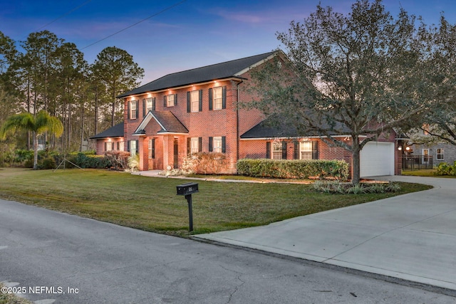 view of front of home featuring a garage and a lawn