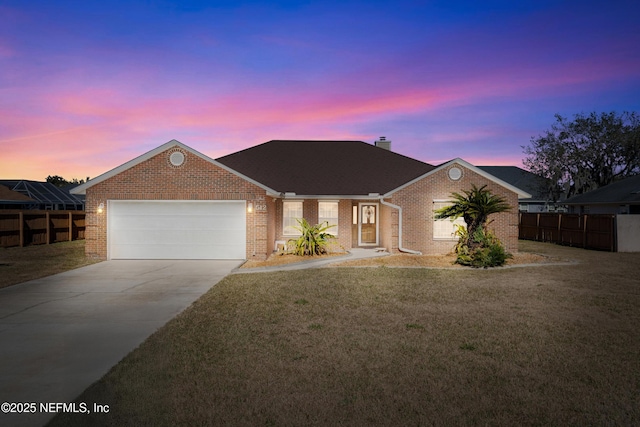 view of front facade featuring a garage and a lawn