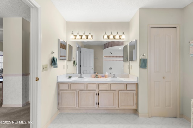 bathroom featuring vanity and a textured ceiling