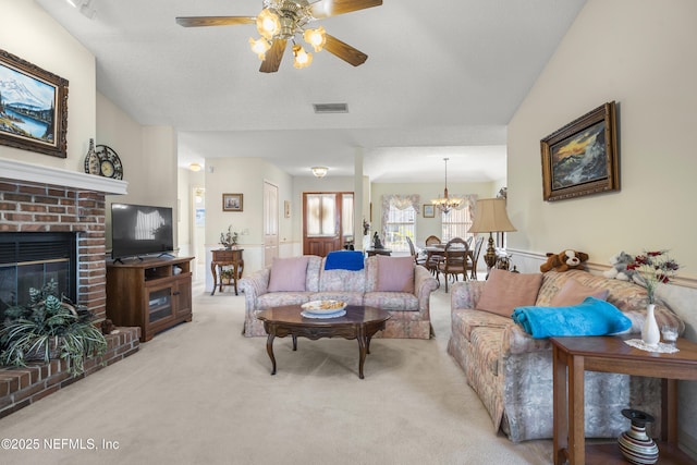 carpeted living room with lofted ceiling, a brick fireplace, a textured ceiling, and ceiling fan