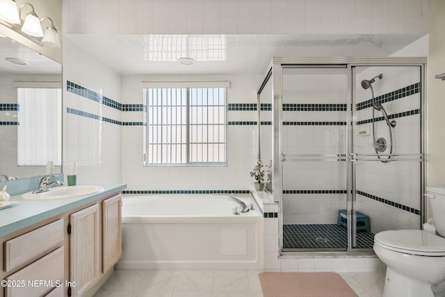 full bathroom with vanity, separate shower and tub, and toilet