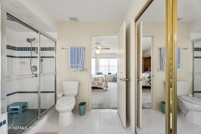 bathroom with a shower with shower door, a textured ceiling, and toilet