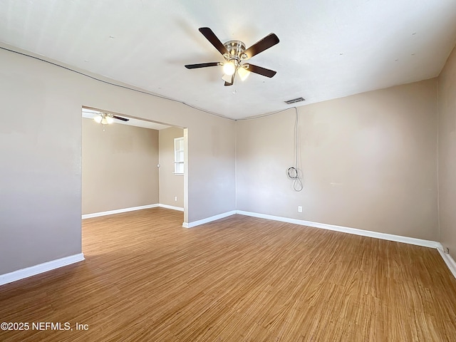 spare room featuring ceiling fan and light hardwood / wood-style floors