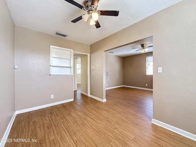 empty room featuring ceiling fan and light hardwood / wood-style flooring