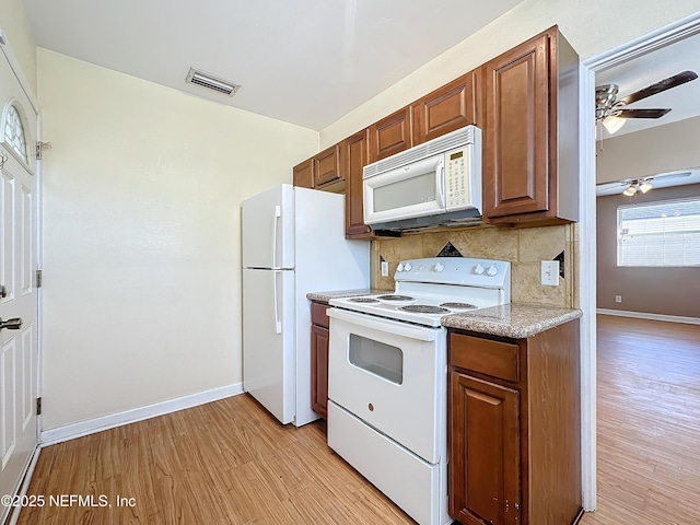 kitchen featuring white appliances, light hardwood / wood-style floors, decorative backsplash, and ceiling fan