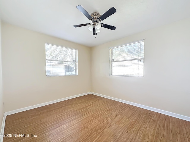 unfurnished room with ceiling fan, hardwood / wood-style floors, and a wealth of natural light