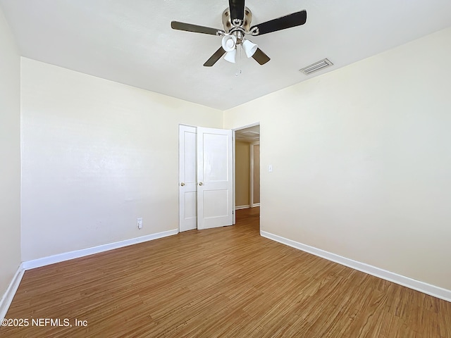 spare room with wood-type flooring and ceiling fan