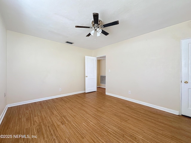 spare room with hardwood / wood-style floors and ceiling fan