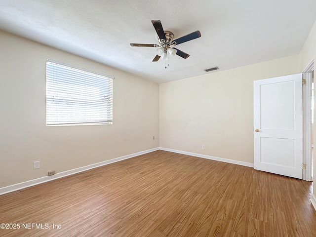 unfurnished room featuring hardwood / wood-style flooring and ceiling fan