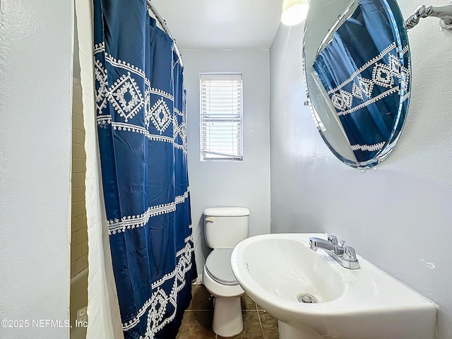 bathroom with sink, tile patterned floors, and toilet