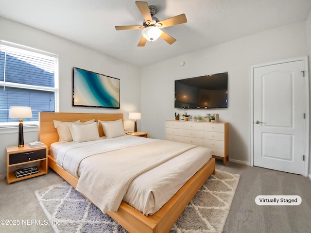 carpeted bedroom featuring multiple windows and ceiling fan