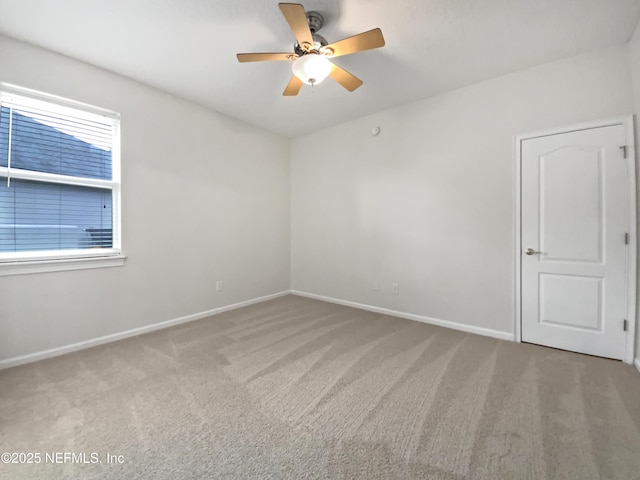 carpeted empty room with a healthy amount of sunlight and ceiling fan