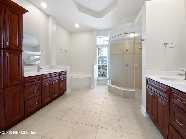 bathroom featuring tile patterned flooring, vanity, and plus walk in shower