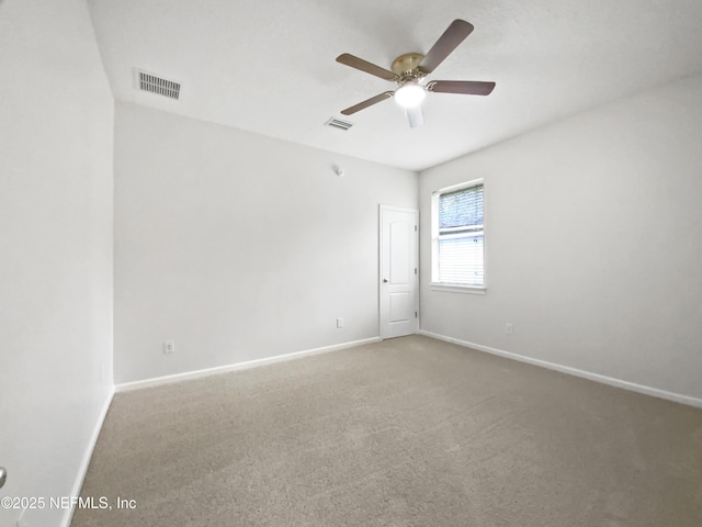 carpeted spare room featuring ceiling fan