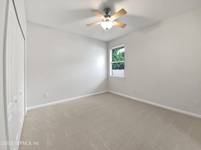 unfurnished bedroom with light carpet, a textured ceiling, a closet, and ceiling fan