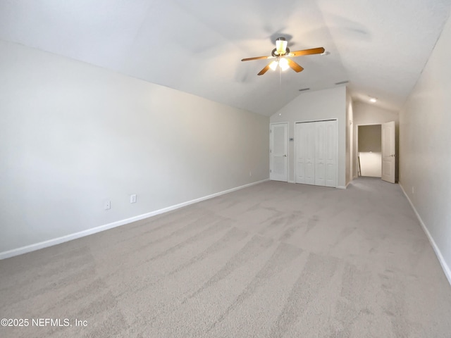 bonus room with ceiling fan, light colored carpet, and vaulted ceiling