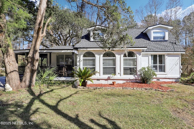 rear view of property featuring a lawn and covered porch