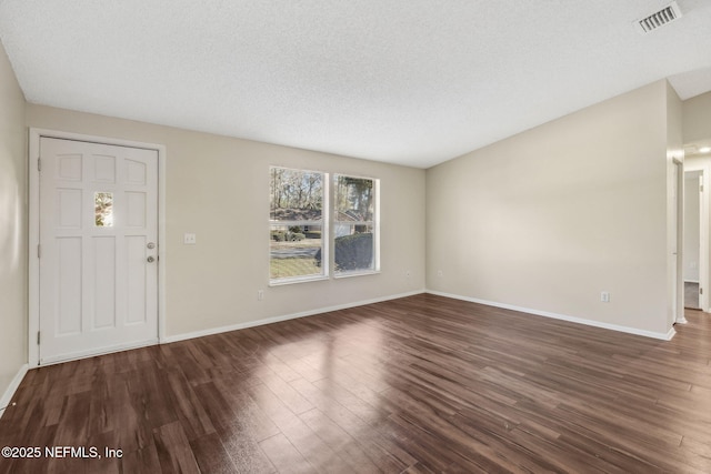 entryway featuring dark hardwood / wood-style floors and a textured ceiling