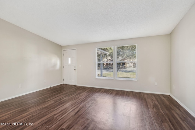 interior space featuring dark wood-type flooring and a textured ceiling