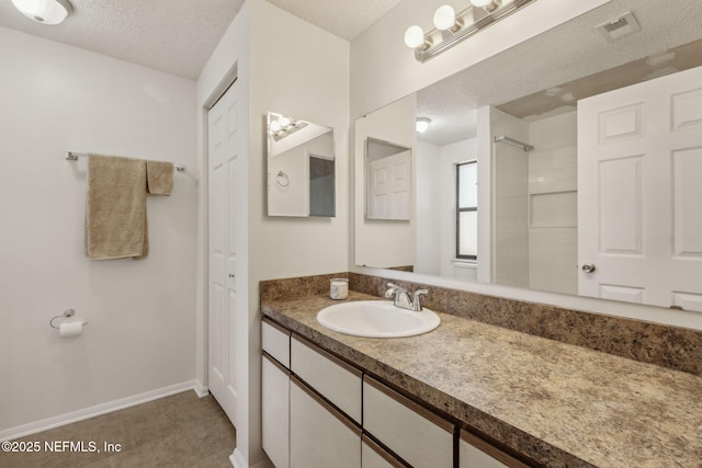 bathroom with vanity and a textured ceiling