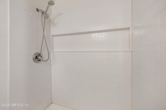 bathroom with a tile shower