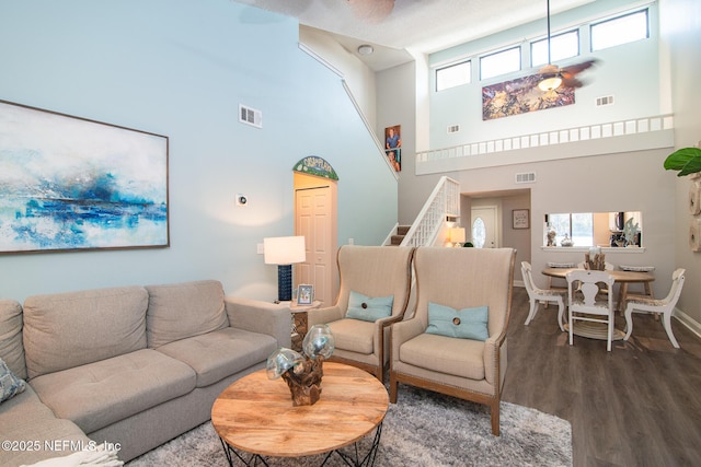 living room with a high ceiling and hardwood / wood-style floors