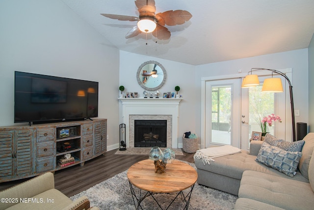 living room with lofted ceiling, hardwood / wood-style floors, and ceiling fan