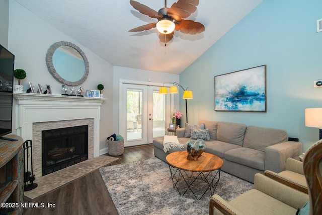 living room featuring lofted ceiling, hardwood / wood-style floors, ceiling fan, and french doors