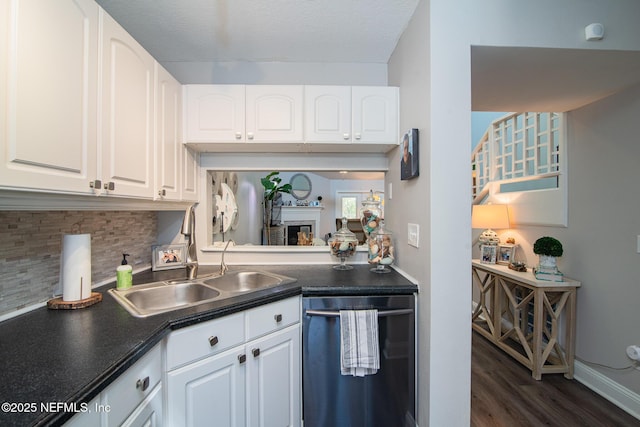 kitchen with white cabinetry, dishwasher, sink, backsplash, and dark hardwood / wood-style flooring