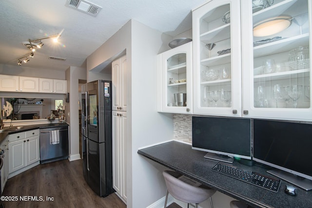 kitchen featuring appliances with stainless steel finishes, backsplash, a textured ceiling, white cabinets, and dark hardwood / wood-style flooring