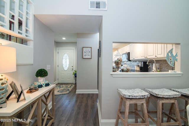 foyer entrance featuring dark hardwood / wood-style floors