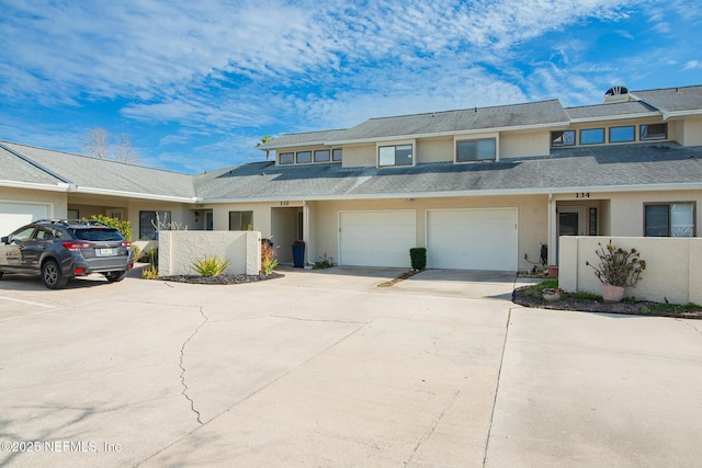 townhome / multi-family property featuring a garage