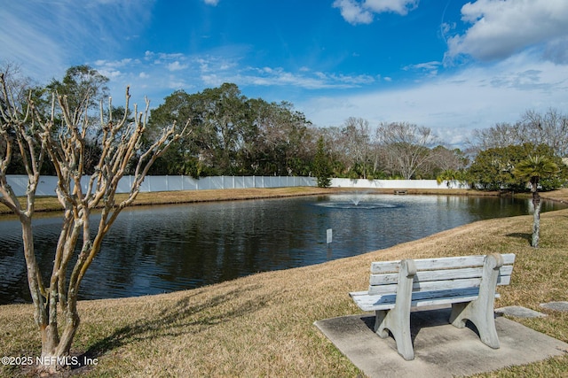 view of community with a water view and a lawn