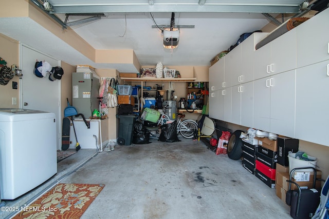 garage with a garage door opener and washer / dryer