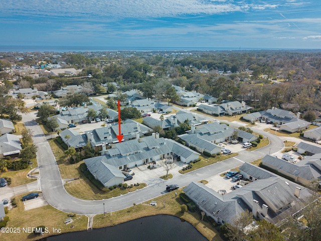 birds eye view of property with a water view