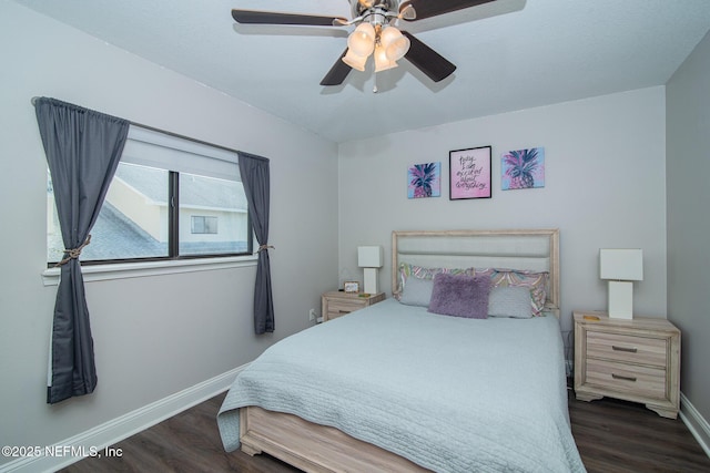 bedroom with ceiling fan and dark hardwood / wood-style floors