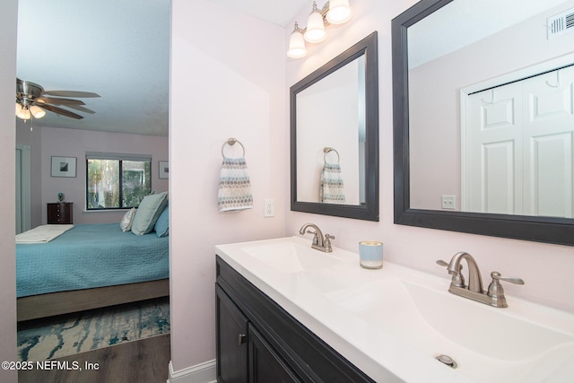 bathroom featuring vanity, hardwood / wood-style floors, and ceiling fan