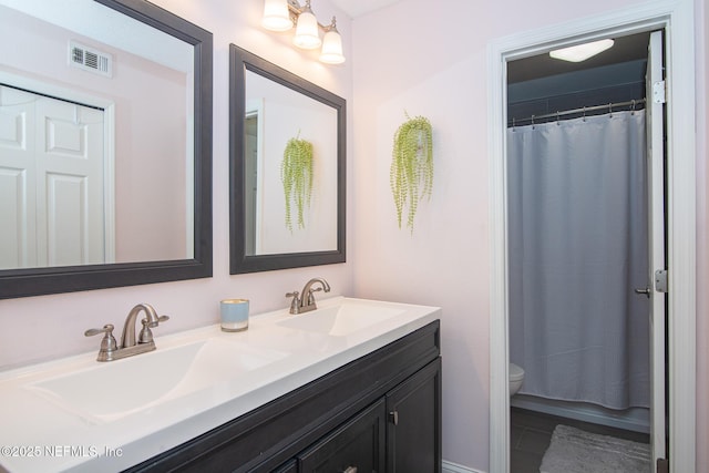 bathroom with vanity, toilet, and a shower with shower curtain